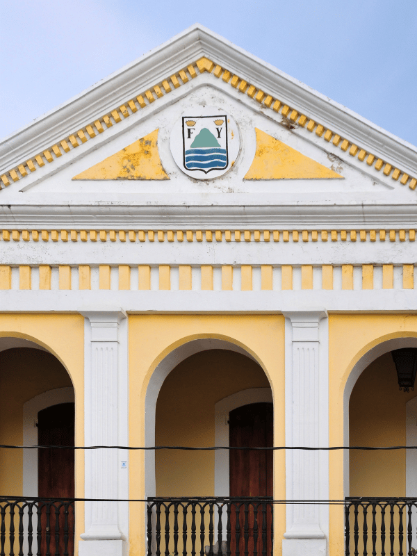 White and yellow colonial-style building that serves as city hall in Puerto Plata, Dominican Republic