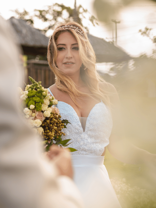 Bride holding a bouquet of greenery