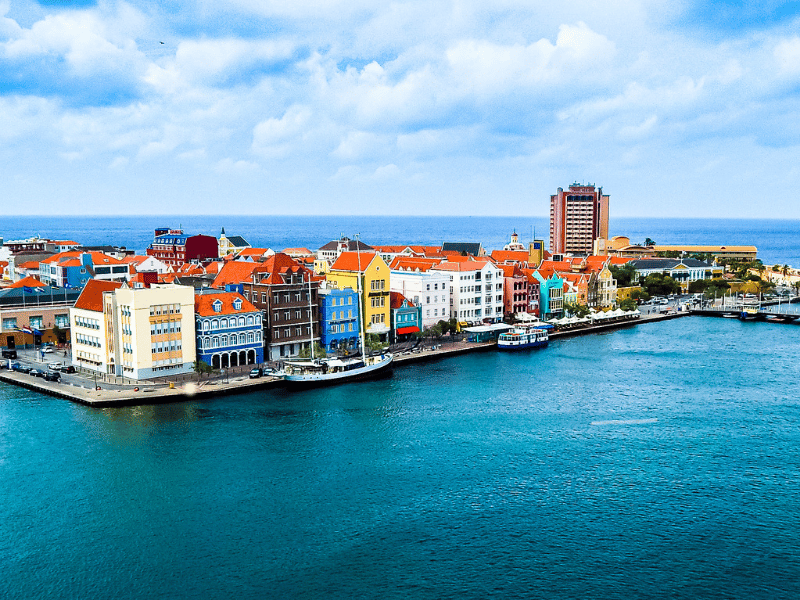 A colorful city next to the ocean in Curacao