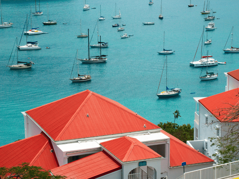Red and white buildings next to a sailboat marina at St. Croix