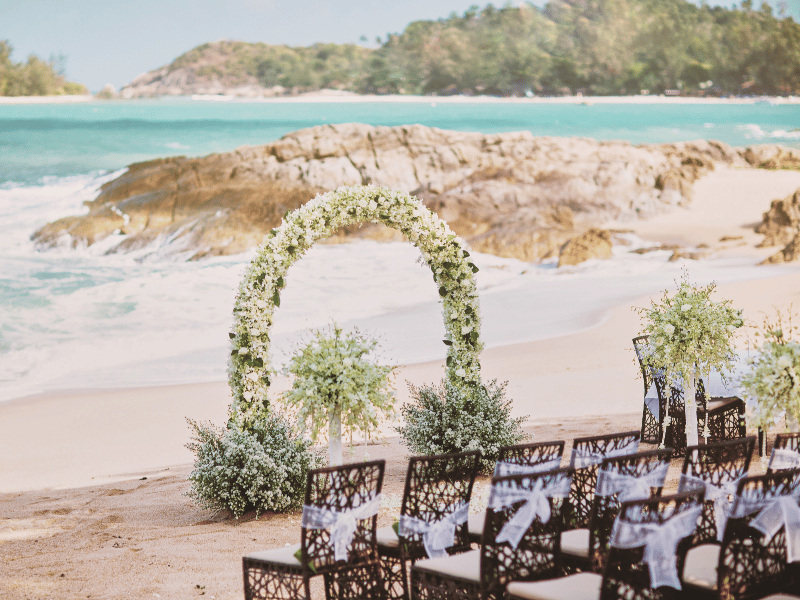 White floral beach destination wedding ceremony