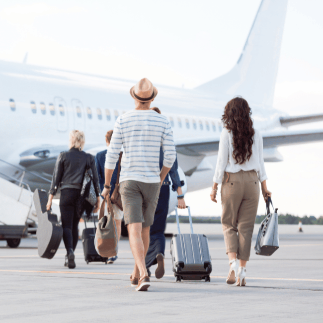 Couple boarding plane to leave for destination wedding