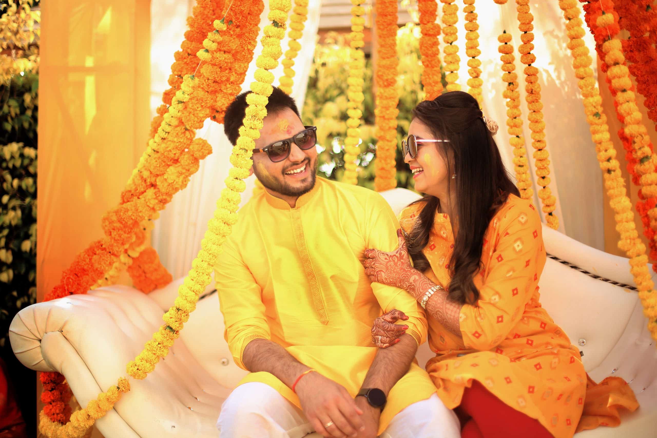 Smiling couple at a haldi for their Indian destination wedding