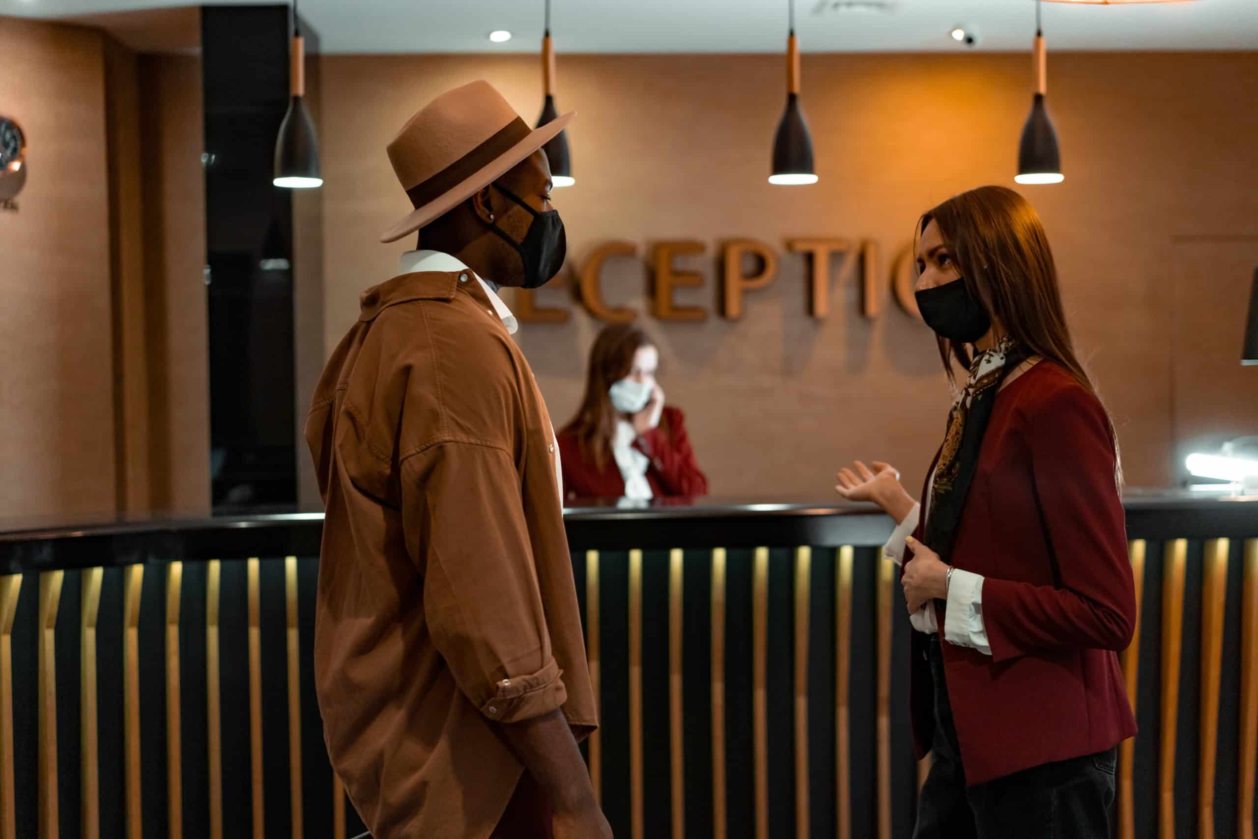 Man and woman talking at a hotel reception area