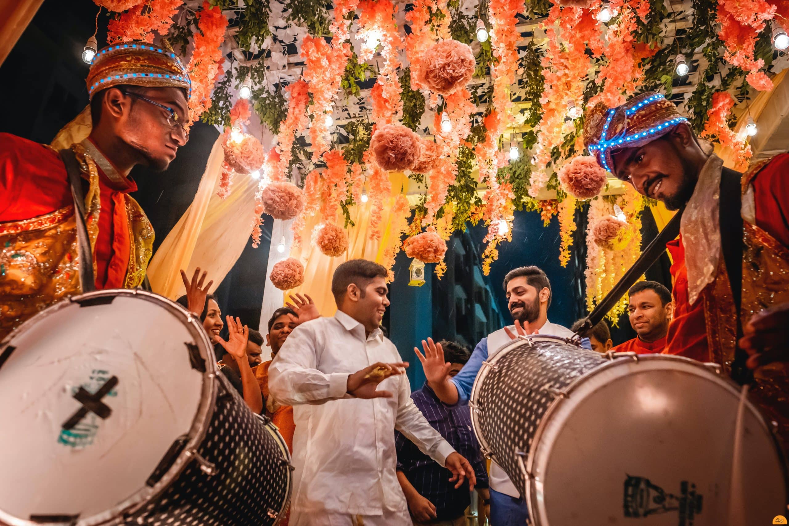 Men dance with drum players at an Indian destination wedding.