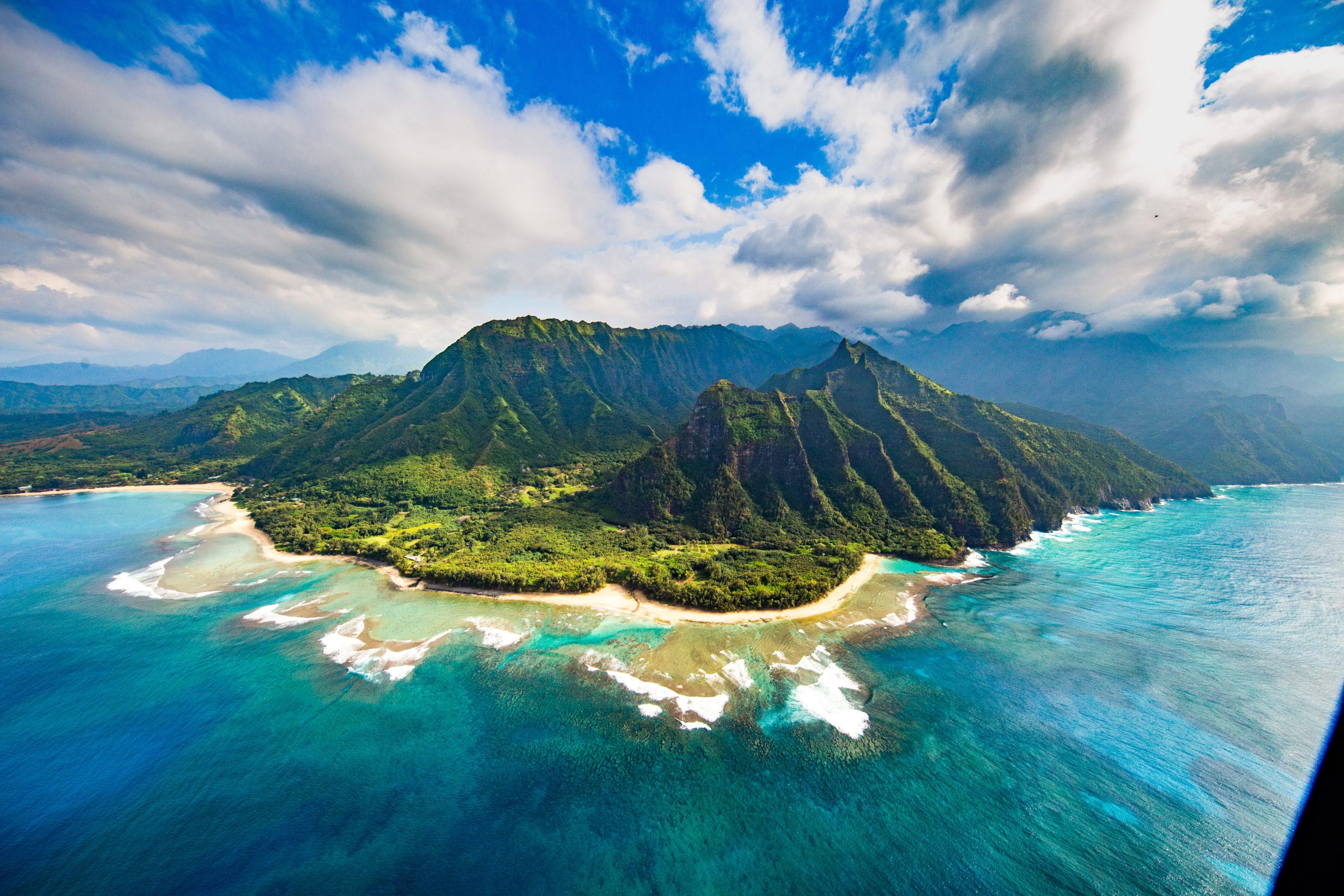 Aerial shot of the beach, ocean, and mountains in Kauai, Hawaii