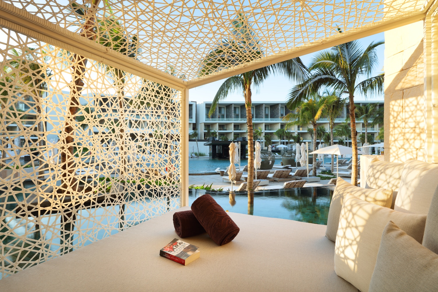 Interior of poolside cabana with white lattice walls at TRS Coral in Costa Mujeres, Mexico