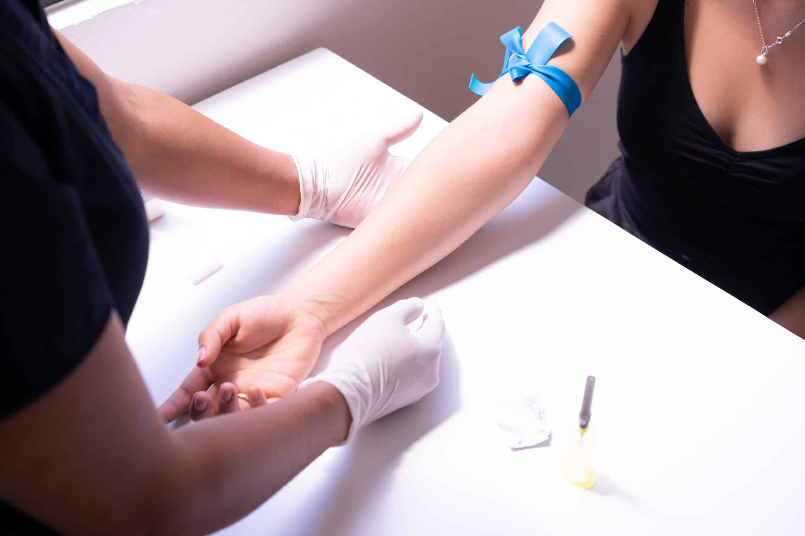 Nurse prepares a woman for a blood test